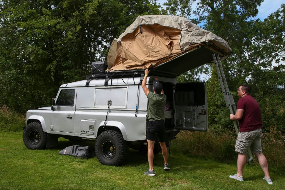 two campers setup a rooftop tent