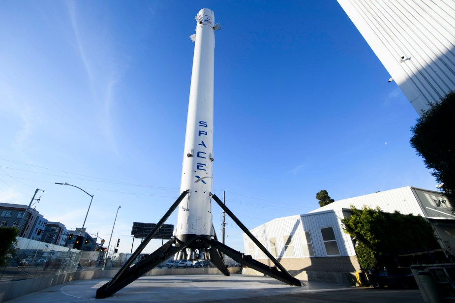 The recovered first stage of a Falcon 9 rocket stands at Space