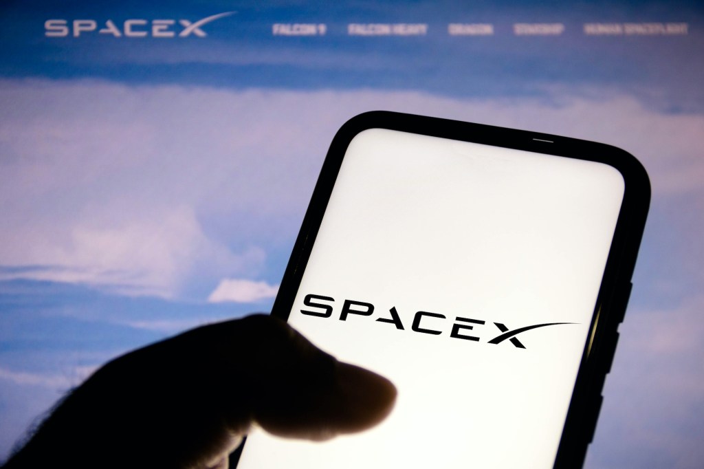 In this photo illustration, a Space Exploration Technologies (SpaceX) logo seen displayed on a smartphone.
