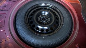 A full-size spare tire stowed in the trunk of a car