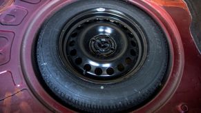 A full-size spare tire stowed in the trunk of a car