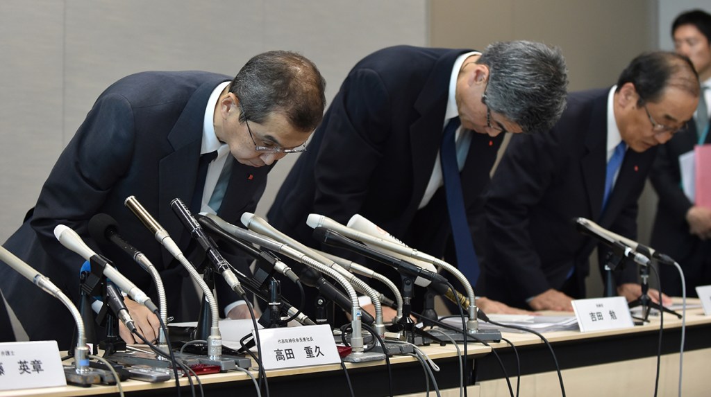 Executives from Takata Corp apologizing during a press conference after the airbag recall