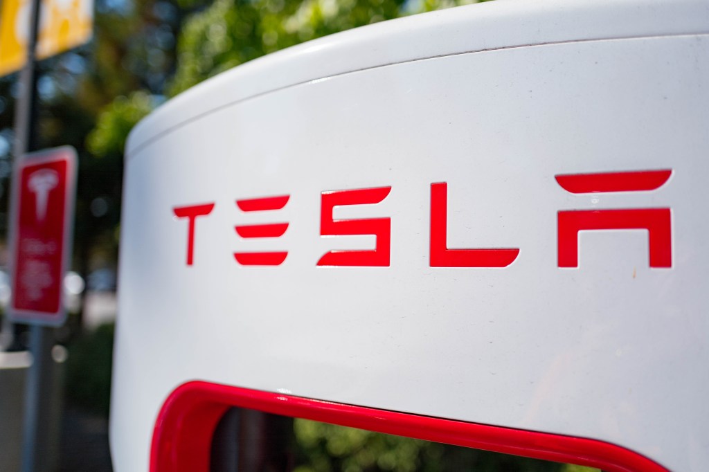 Close up of Tesla logo on a charger at a Supercharger rapid battery charging station