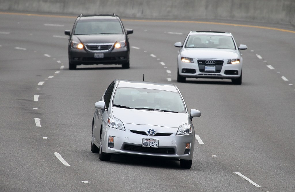 A Toyota Prius drives along highway 101