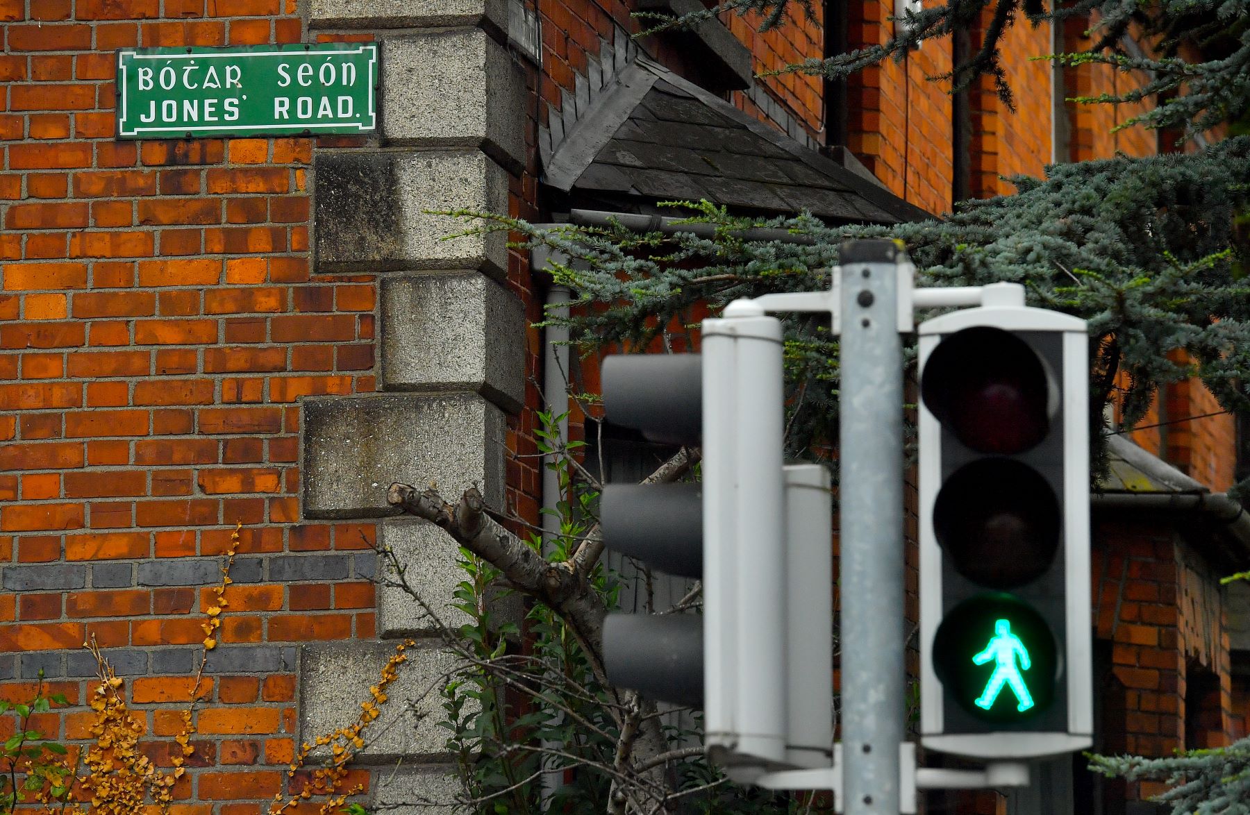 A traffic light with a green walk signal on Jones' Road near Croke Park Stadium in Dublin, Ireland