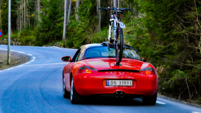 a vacuum mounted bike rack on a porsche driving down the road