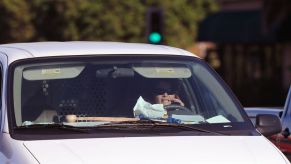A distracted woman driver eating and talking on the phone in Long Beach, California