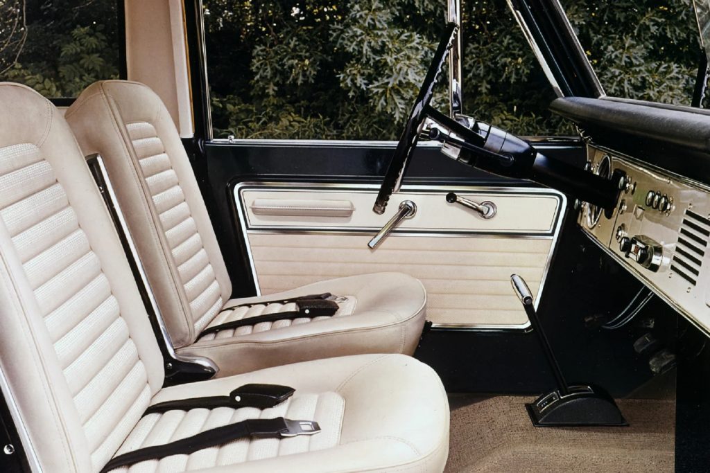 The white-and-black front interior of a 1967 Ford Bronco Sport