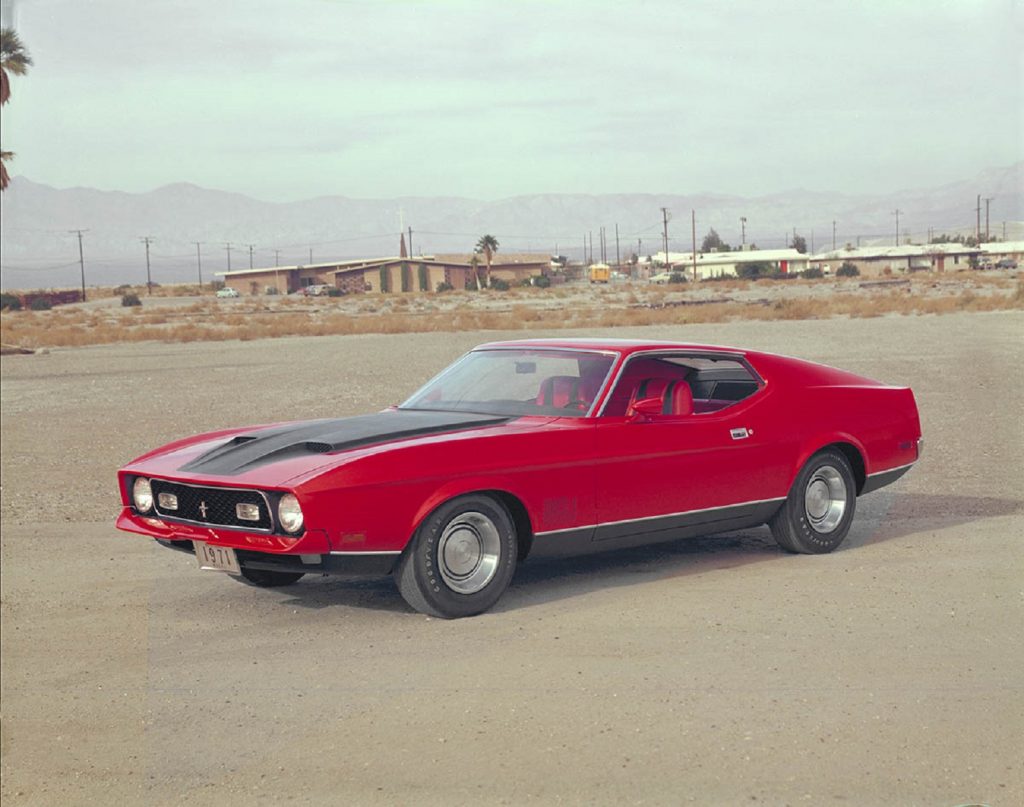 A red-and-black 1971 Ford Mustang Mach 1 on a desert runway