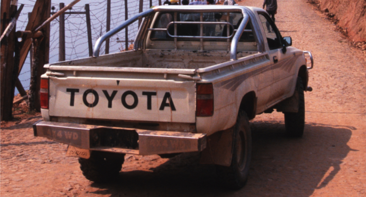 A white 1986 Toyota Pickup truck