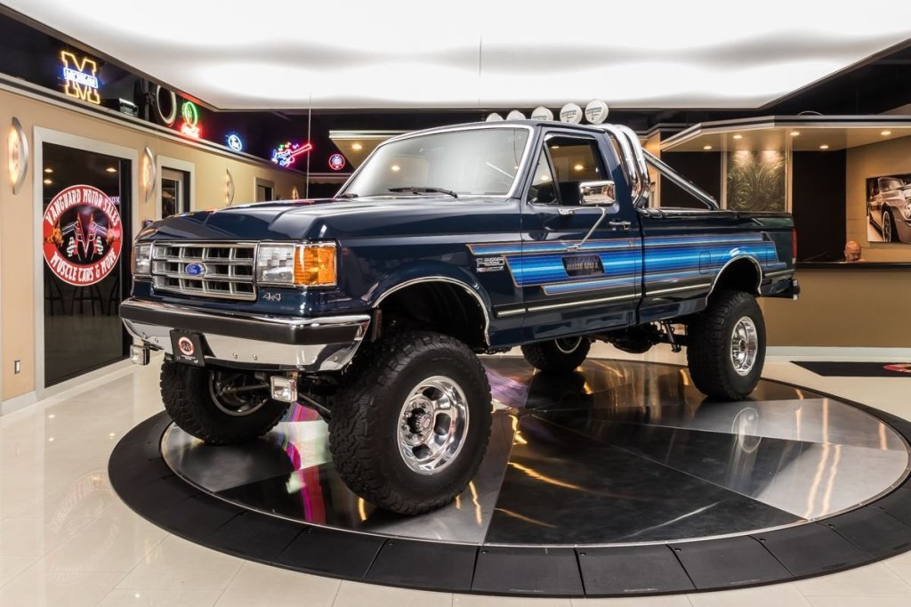 A 1987 Ford F-250 Bigfoot Cruiser parked inside a showroom