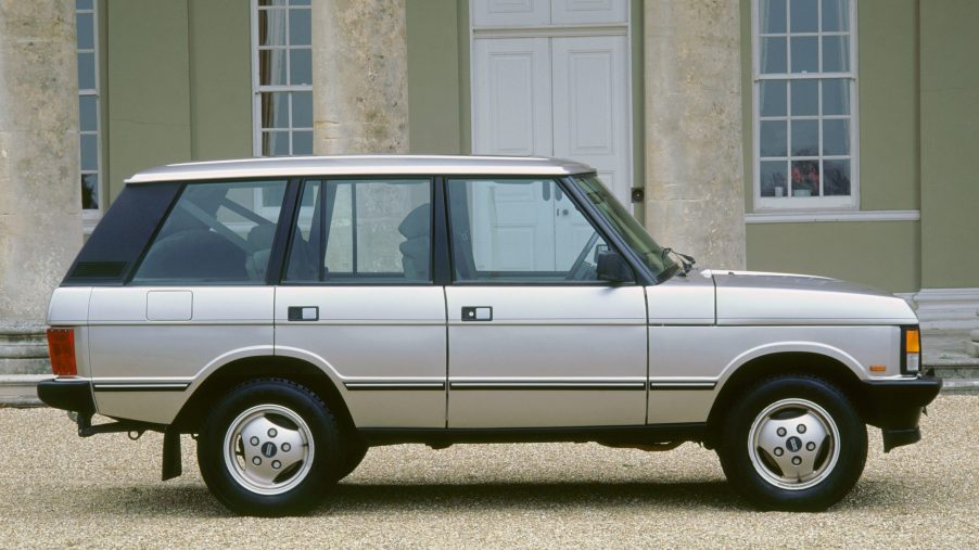 A silver 1993 Range Rover classis parked outside, it's the first step in the evolution of the Range Rover.