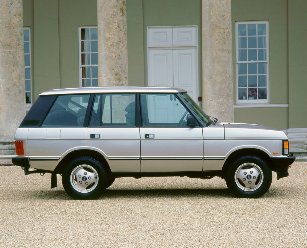 A silver 1993 Range Rover classis parked outside, it's the first step in the evolution of the Range Rover.
