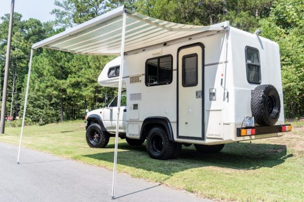 A Toyota Galaxy camper with its awning out