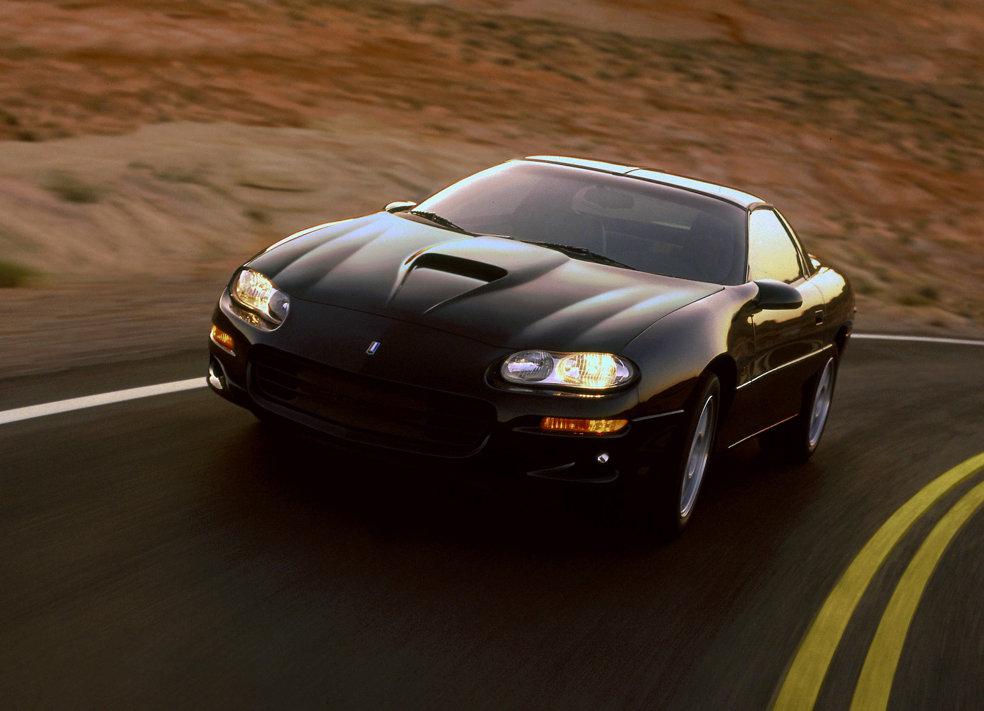 The 1998 Chevrolet Camaro SS in black shot in motion from the front 3/4 angle