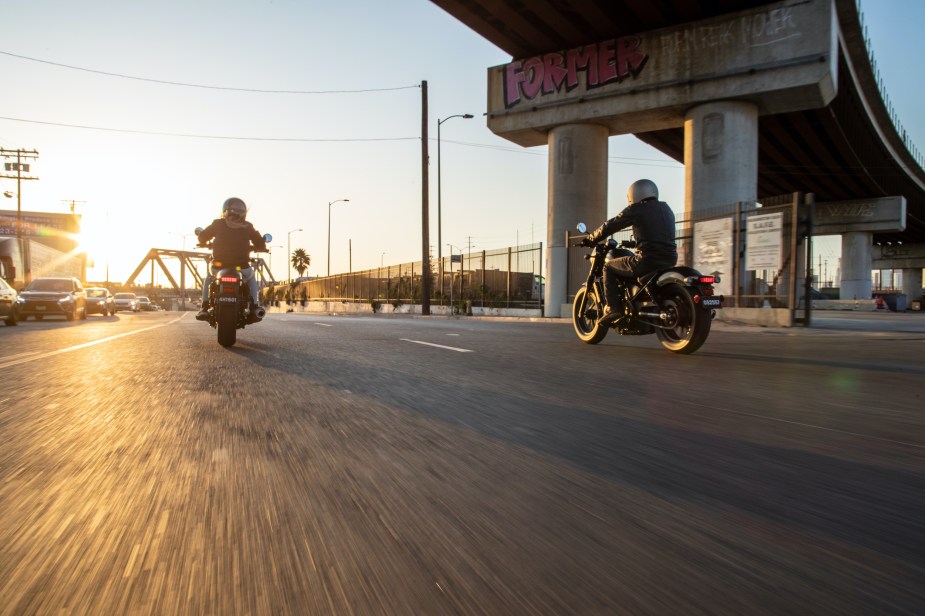 Riders riding a honda Rebel in to the sunset