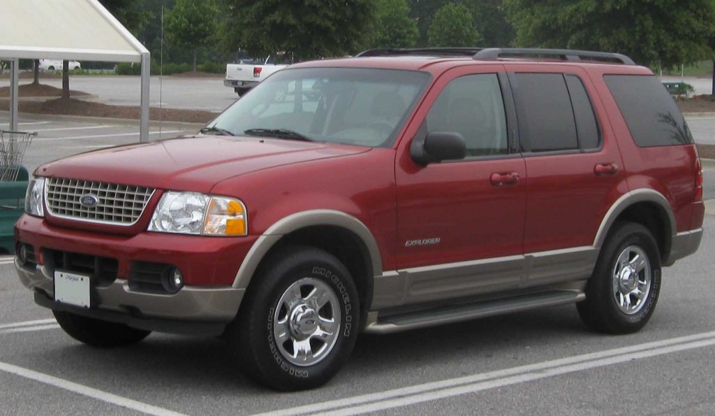 A red 2002 Ford Explorer parked in a parking lot