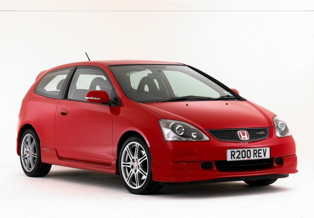 A red 2005 Honda Civic Type R, shot from the front 3/4 against a white studio background