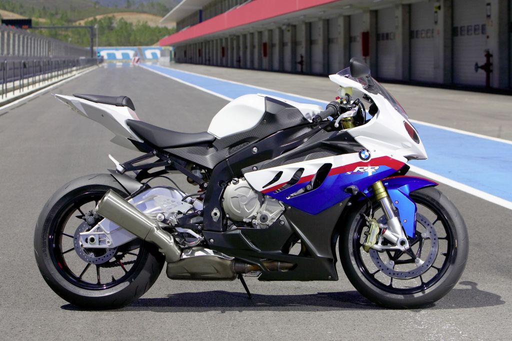 The side view of a white-blue-and-red 2010 BMW S 1000 RR on a racetrack