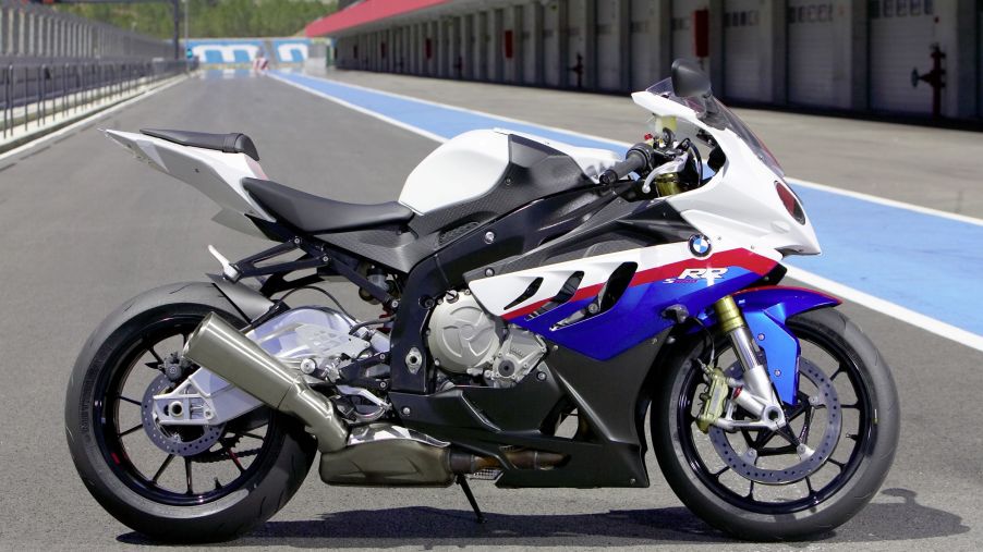 The side view of a white-blue-and-red 2010 BMW S 1000 RR on a racetrack