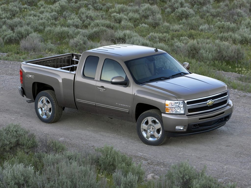 A gray 2012 Chevrolet Silverado 1500 parked on farm land somewhere