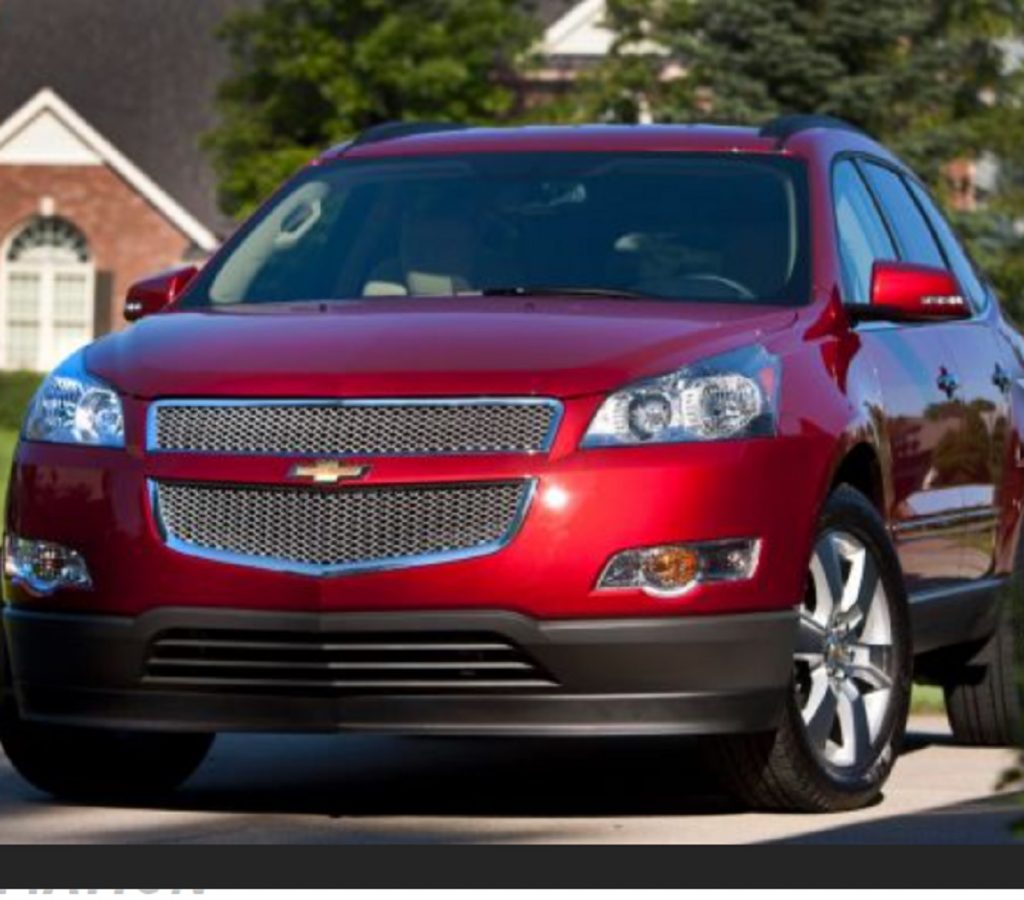A red 2012 Chevy Traverse parked in a neighborhood.