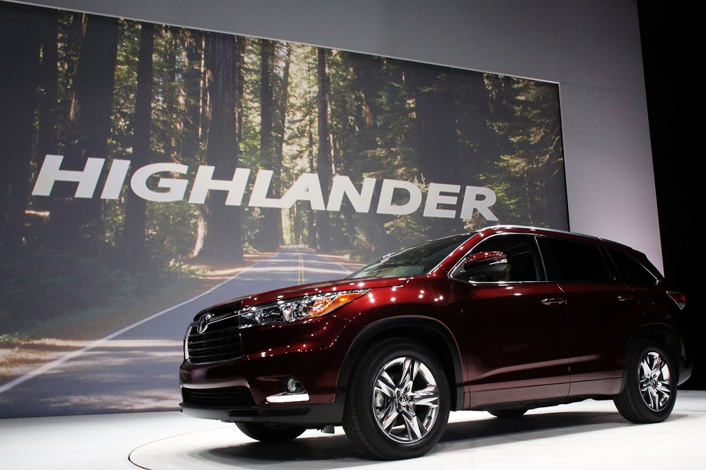 A red 2014 Toyota Highlander parked at the New York international auto show, in 2021 it's a great option for a used midsize SUV.
