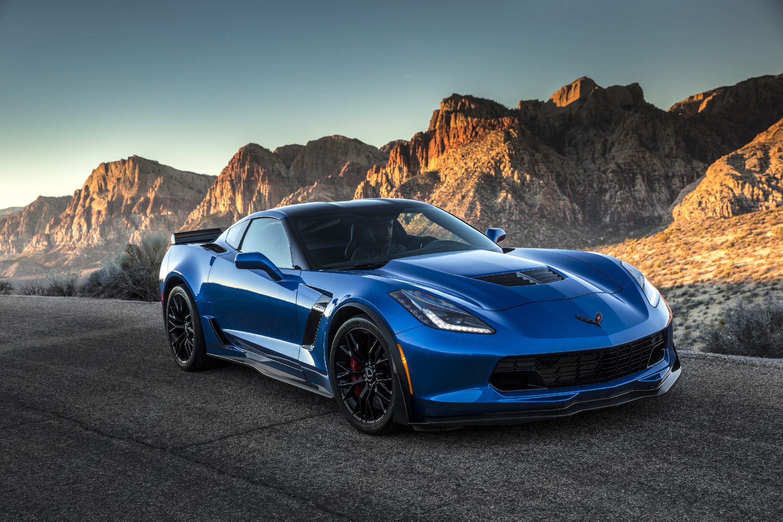 A blue 2019 Chevrolet Corvette Z06 shot from the front 3/4 on a California canyon road