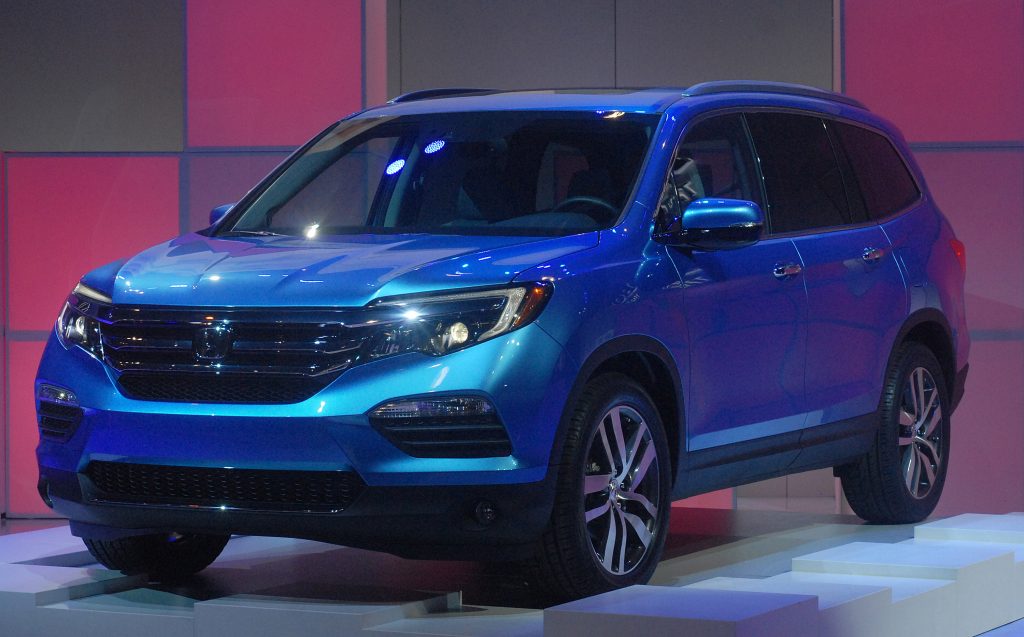 A blue 2015 Honda Pilot parked at the Chicago Auto Show press preview, in 2021 it's a great option for a used midsize SUV.