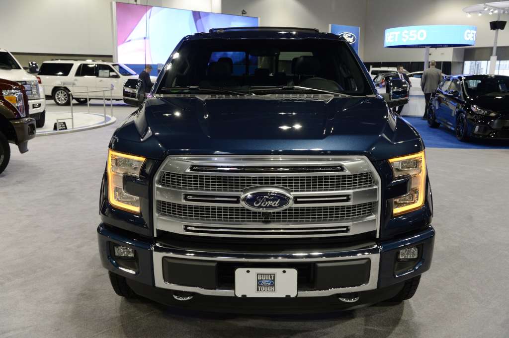 A blue 2016 Ford F-150 at an auto show