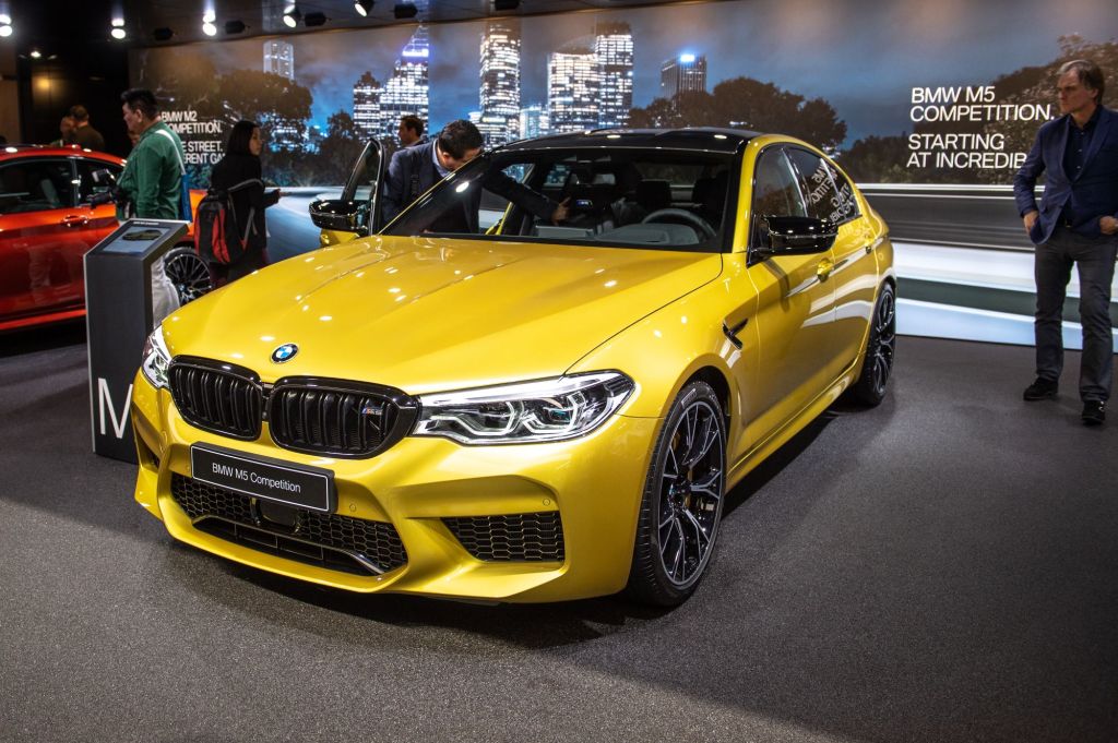 A yellow 2019 BMW M5 sitting inside a building.