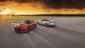 A red 2021 Chevrolet Camaro ZL1 coupe and convertible at sunset