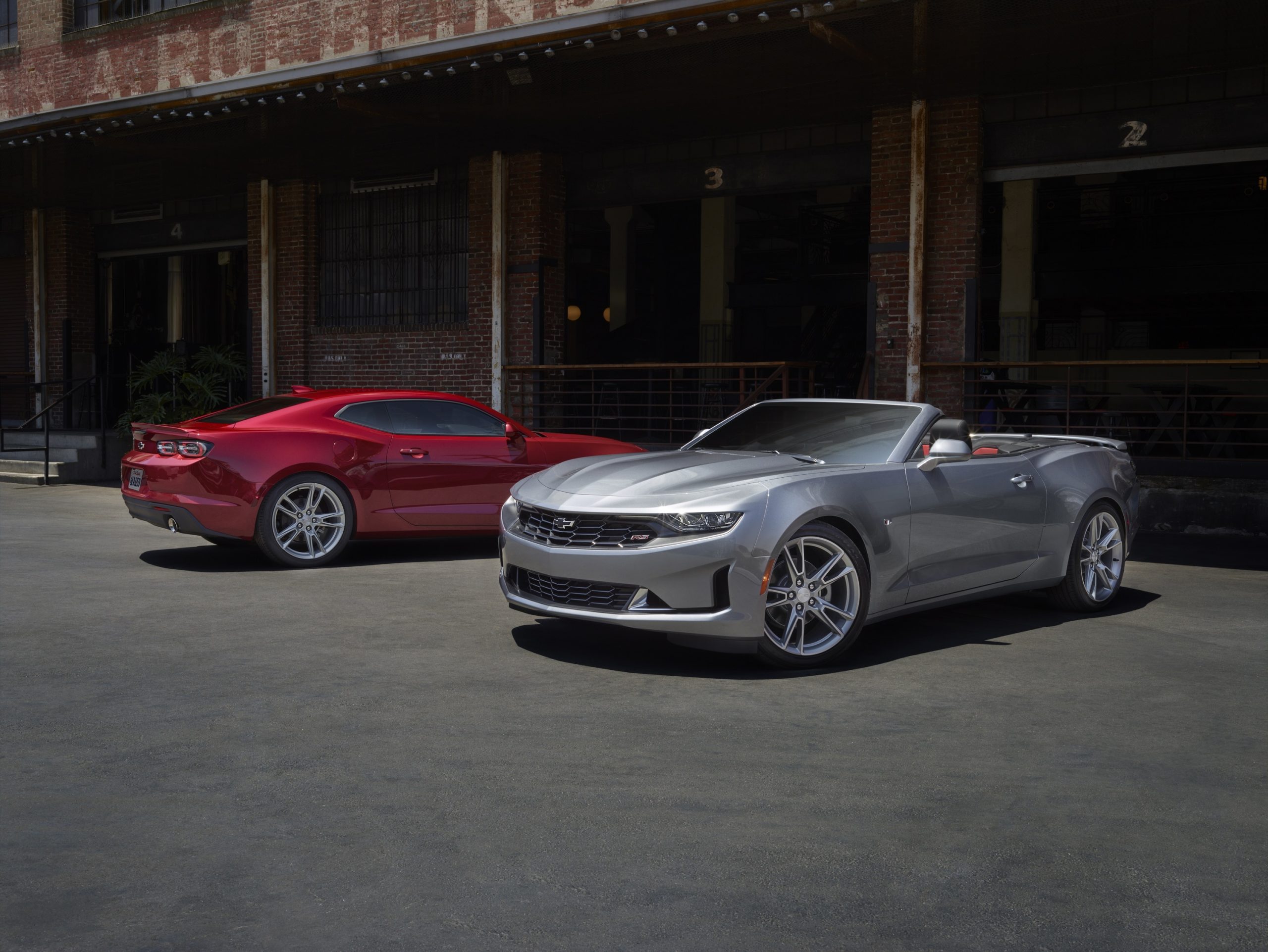 A silver and red 2022 Chevrolet Camaro convertible and coupe shot from the 3/4 angle