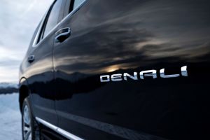 A closeup exterior shot of the 2021 GMC Yukon Denali's Denali trim level name badging