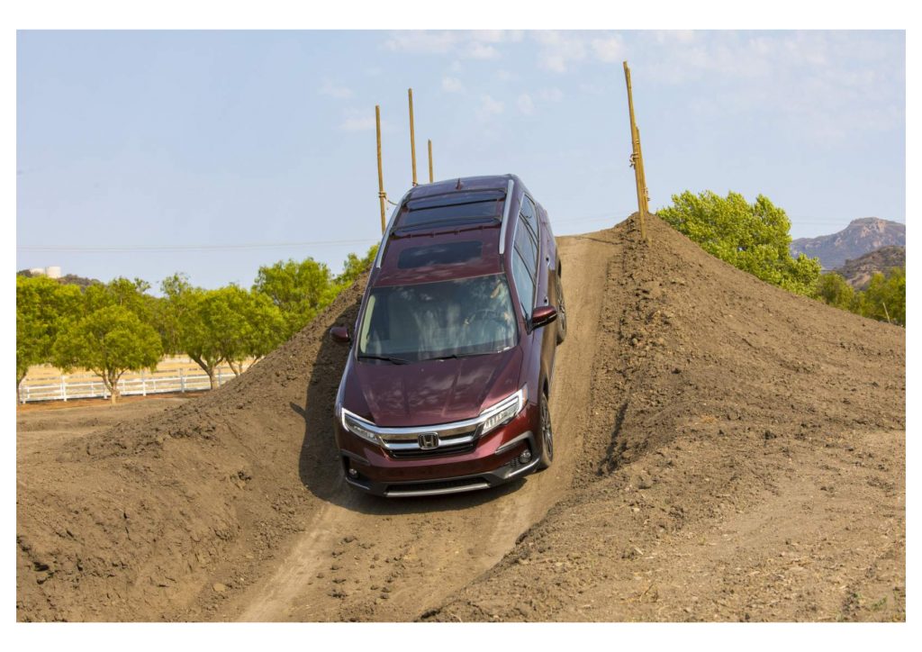A maroon 2022 Honda Pilot drives off-road in the dirt, it's one of the best SUV deals of November 2021