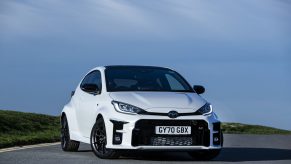A white 2021 Toyota GR Yaris shot from the front 3/4 on an open road