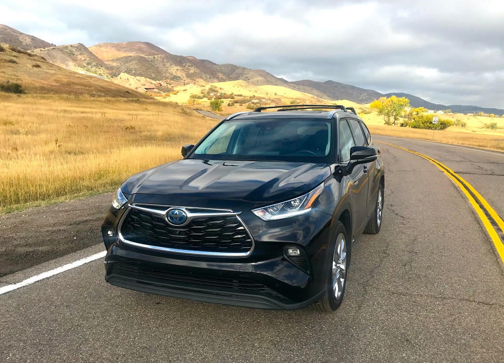 A front shot of the 2021 Toyota Highlander Hybrid on a public road for our full review.