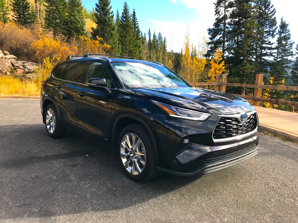 The 2021 Toyota Highlander Hybrid sitting in a forest setting.
