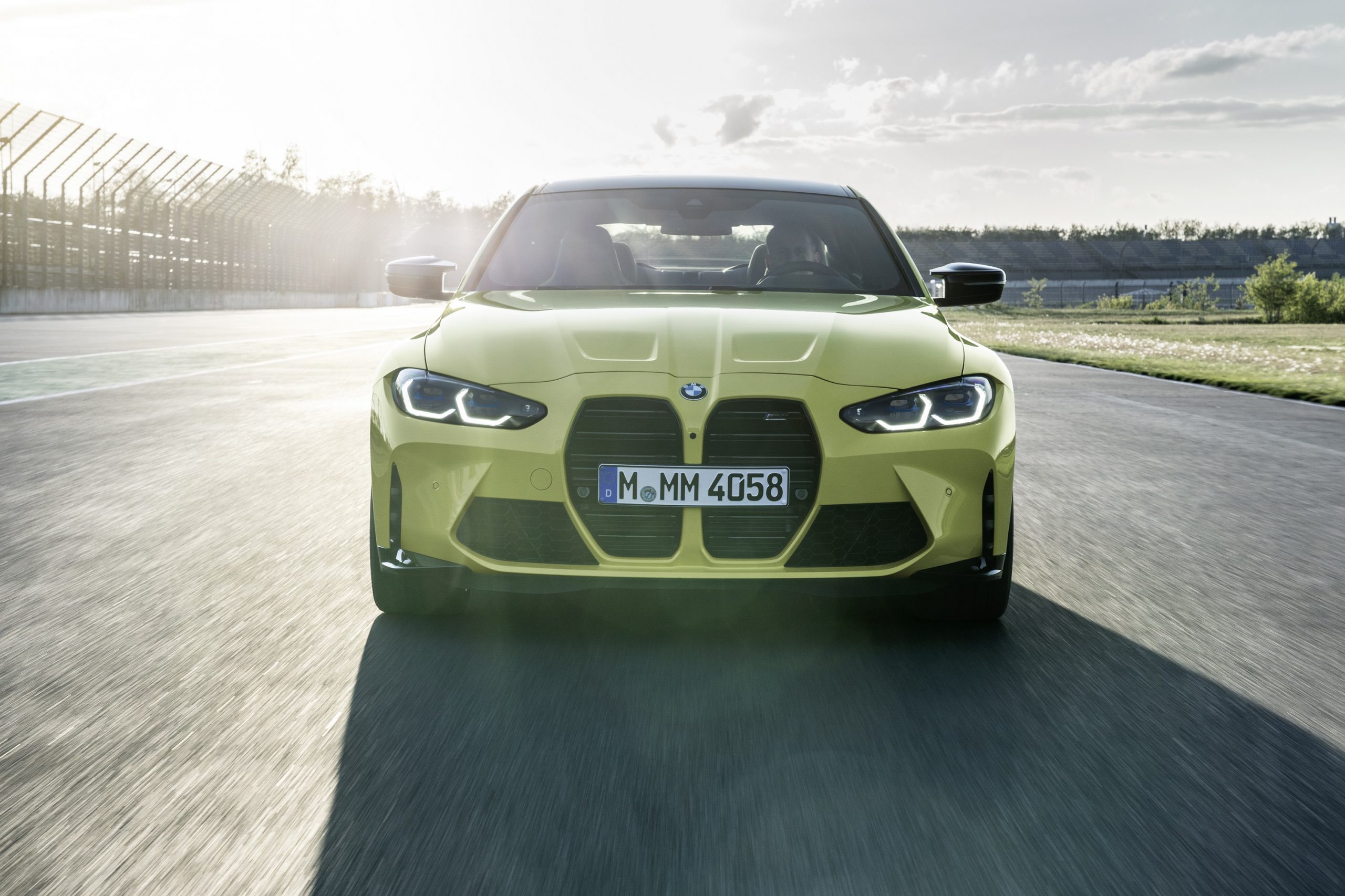 The 2021 BMW M4 kidney grille shot from the front on a racetrack