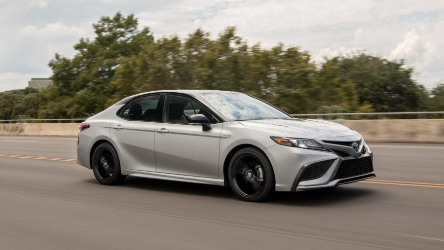 2021 Toyota Camry Hybrid XSE driving down the road
