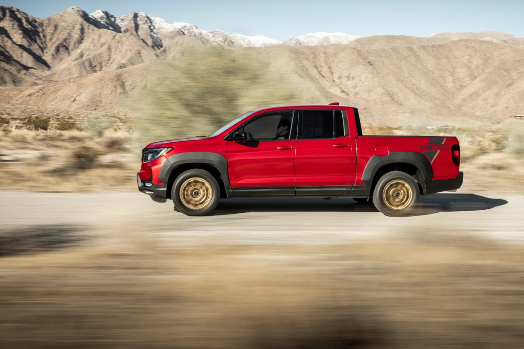 A side shot of the 2021 Ridgeline Sport shown in red.
