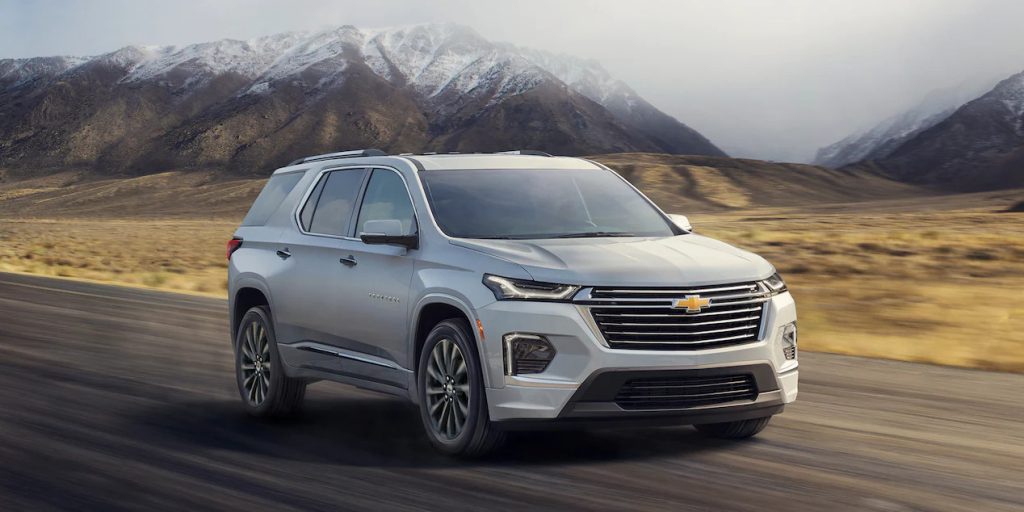 A silver 2022 Chevy Traverse driving on a road