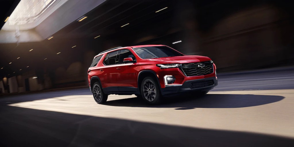 A red 2022 Chevy Traverse driving through a tunnel, what's new with it for 2022?