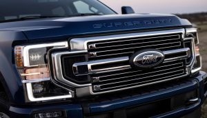 The front end grille and headlights of a 2022 Ford F-Series Super Duty Limited pickup truck model