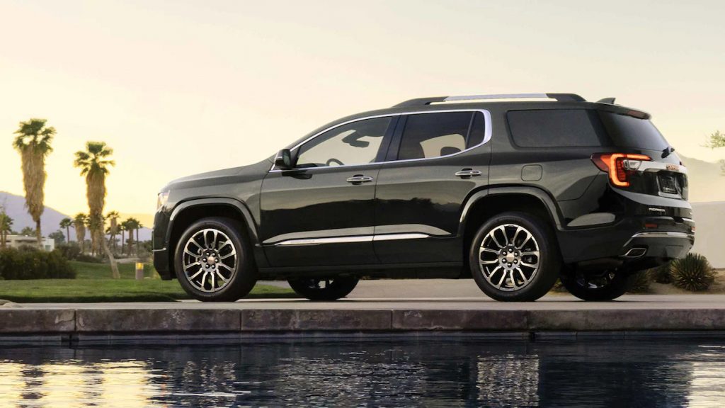 A 2022 GMC Acadia Denali parked outside near some water