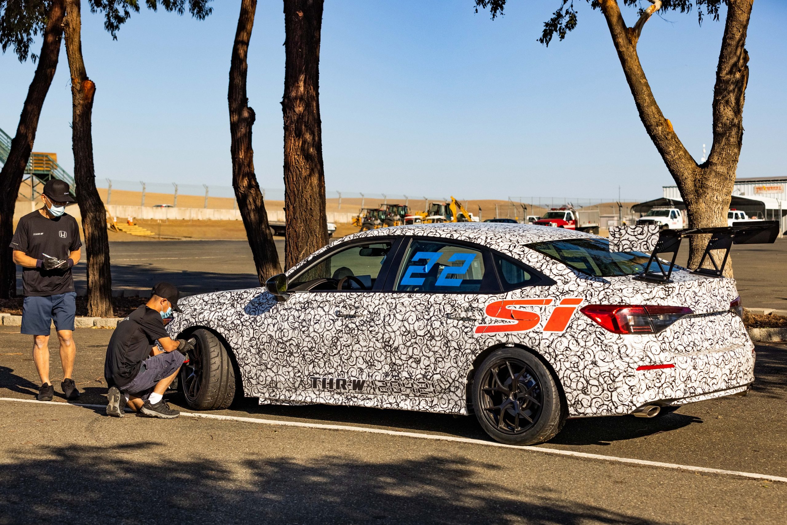 The white camo 2022 Civic Si gets its tires changed at a race track