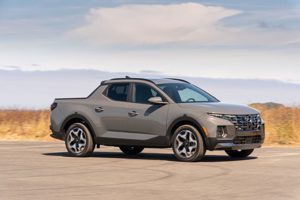 The 2022 Hyundai Santa Cruz sport adventure vehicle truck model parked in the middle of a parking lot, it's one of the best affordable small pickup trucks of 2022.