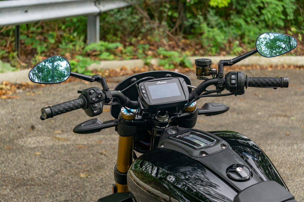 The rider view of a black accessorized 2022 Indian FTR S's handlebars and TFT display