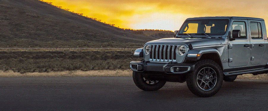 A gray 2022 Jeep Gladiator against a sunset.