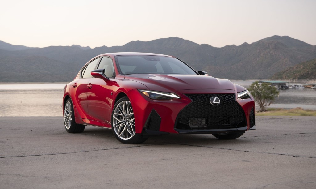A red 2022 Lexus IS 500 F Sport on a concrete area with hills behind it.